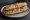 Sandwich Rillettes de Porc: an illustration of pork, pickle, mustard and pepper on baguette.