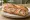 Sandwich Rillettes de Saumon: an illustration of salmon, lemon, dill, onion and more on baguette.