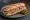 Sandwich Rillettes d'Oie: an illustration of pickle, mustard and pepper on baguette.