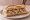 Sandwich Rillettes du Mans: an illustration of pork, pickle and pepper on baguette.