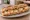 Sandwich Rocamadour-Miel: an illustration of honey, walnuts, olive oil and pepper on baguette.