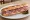 Sandwich Rosette: an illustration of butter, pickle and garlic on baguette.