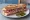 Sandwich Rosette de Lyon: an illustration of butter, pickle and garlic on baguette.