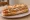 Sandwich Saucisse de Strasbourg: an illustration of mustard and onion on baguette.