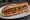 Sandwich Saucisse de Toulouse: an illustration of pork and mustard on baguette.