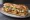 Sandwich Tablier de Sapeur: an illustration of mustard and pickle on baguette.