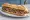 Sandwich Taureau de Camargue: an illustration of beef, butter, mustard and onion on baguette.