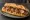 Sandwich Toulouse: an illustration of pork, butter, mustard, onion and more on baguette.