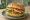 Sandwich z Halloumi: an illustration of halloumi, tomato, cucumber and lettuce on bread.