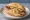 Sauerkraut Bratwurst: an illustration of sauerkraut and mustard on kaiser roll.