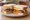 Sausage and Egg: an illustration of butter, egg, ketchup and brown sauce on white bread.