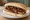 Sausage and Onion: an illustration of butter, onion and brown sauce on white bread.