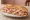 Schiacciata con Mortadella: an illustration of mortadella, olive oil and pistachio.