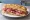 Schiacciata con Salame Toscano: an illustration of salami, pork and garlic.