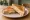 Schinken-Käse Toast: an illustration of ham, cheese and butter on bread.