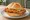 Schnitzel Brötchen: an illustration of pork, olive oil and mustard on kaiser roll.