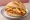 Schnitzel mit Pommes Brötchen: an illustration of pork, potato and mustard on kaiser roll.