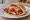Schnitzel Parmesan b'Pita: an illustration of chicken, turkey, marinara, parmesan and more on pita.