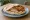 Schnitzel with Hummus (שניצל עם חומוס): an illustration of chicken, turkey, hummus and tahini on pita.