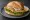 Schollenbrötchen: an illustration of remoulade, lettuce and lemon on kaiser roll.