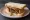 Scotch Pie Sandwich: an illustration of lamb, beef, onion and pepper on white bread.