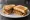 Scrapple Sandwich: an illustration of pork, ketchup and mustard on white bread.
