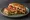 Sebzeli Tost: an illustration of cheese, tomato, pepper, onion and more on bread.
