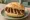 Sechs im Weggla: an illustration of mustard on kaiser roll.