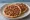 Sfiha (صفيحة): an illustration of beef, onion and tomato.