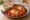 Shakshuka with Bread: an illustration of egg, tomato, onion, bell pepper and more on pita.