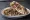 Shawarma de Carne: an illustration of beef, tahini, tomato, onion and more on pita.
