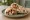 Shish Taouk b'Khubz (شيش طاووق بالخبز): an illustration of chicken, garlic, lemon, yogurt and more on pita.
