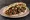 Shishlik b'Pita (שישליק בפיתה): an illustration of lamb, beef, onion, tomato and more on pita.