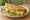 Shǒuzhuā Bǐng (手抓饼): an illustration of egg, ham, cheese, lettuce and more.