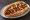 Sonoran Hot Dog: an illustration of hot dog, bacon, onion, tomato and more on telera roll.