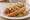 Sonoran Hot Dog (Dogos): an illustration of hot dog, bacon, onion, tomato and more on telera roll.