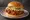 Soy-Garlic Chicken Sandwich: an illustration of chicken, maggi seasoning sauce, garlic, mayonnaise and more on burger bun.