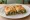 Spanakopita (Σπανακόπιτα): an illustration of spinach, feta, onion, dill and more.