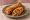 Spring Roll: an illustration of chicken, cabbage, carrot, onion and more on white bread.