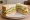 St. Paul Sandwich: an illustration of egg, sprouts, onion, mayonnaise and more on white bread.