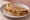 Staffordshire Oatcake with Sausage: an illustration of cheddar cheese and butter.