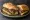 Steak de Burgo Sandwich: an illustration of beef, butter, garlic, basil and more on hoagie roll.
