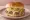 Steamed Cheeseburger: an illustration of beef, cheddar cheese, mustard and onion on burger bun.