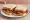 Streaky Bacon Butty: an illustration of butter and brown sauce on white bread.