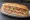 Submarine Sandwich: an illustration of ham, salami, provolone, lettuce and more on hoagie roll.