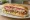 Submarine/Sub/Grinder/Hero/Hoagie/Wedge/Po' Boy: an illustration of ham, salami, provolone, lettuce and more on hoagie roll.