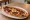 Sucuklu Pide: an illustration of sucuk, beef, cheese and garlic on pita.