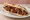 Sujuk Meshwi (سجق مشوي): an illustration of beef and garlic on pita.
