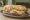 Suprema Completa: an illustration of chicken, cheese, ham, egg and more on baguette.