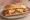 Suprema Napolitana: an illustration of chicken, ham, marinara and mozzarella on baguette.